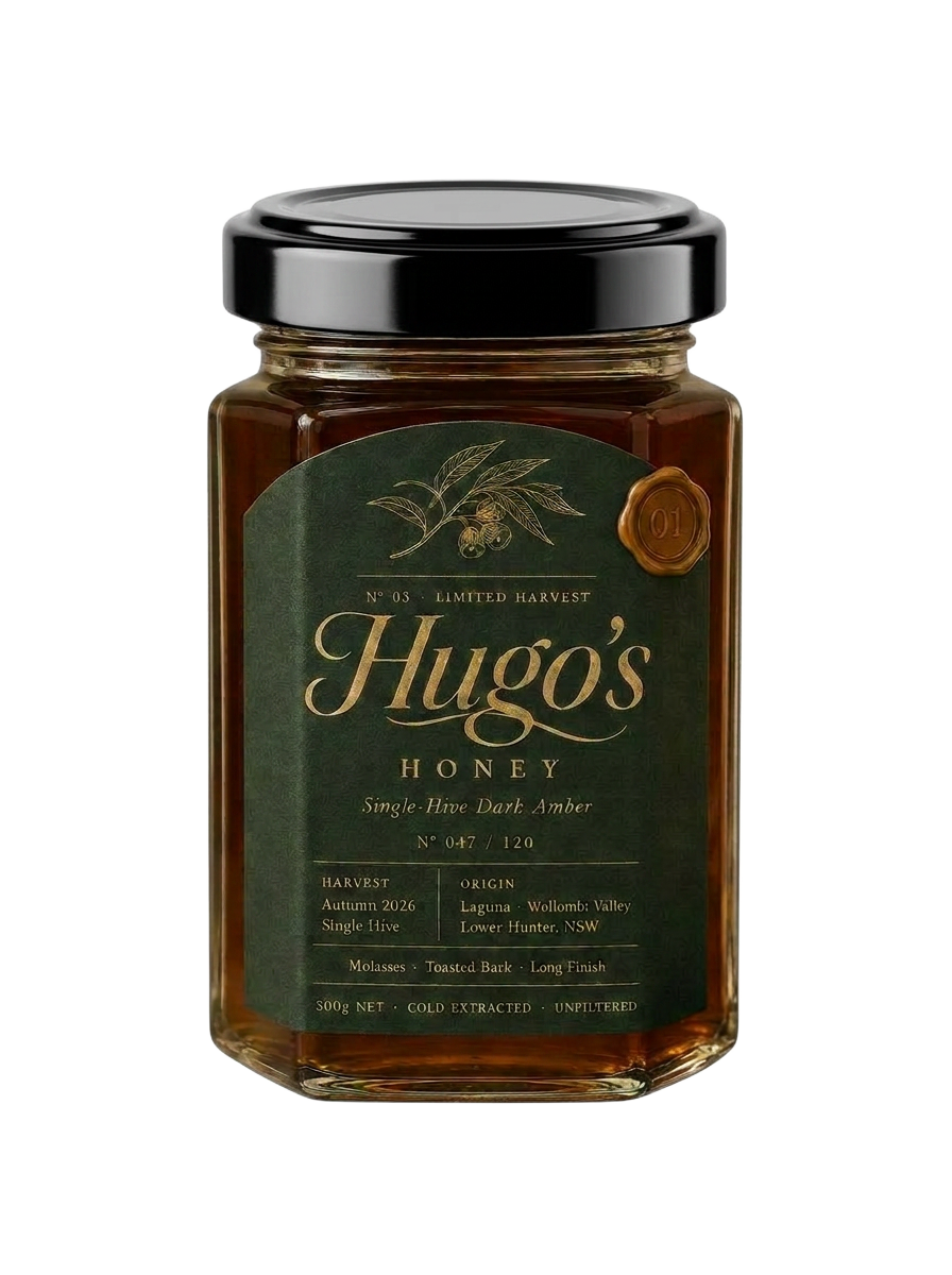 Numbered jar of Hugo's Honey Limited Harvest single-hive honey, dark glass with a shiny ridged lid, set against twilight over the Hunter Valley